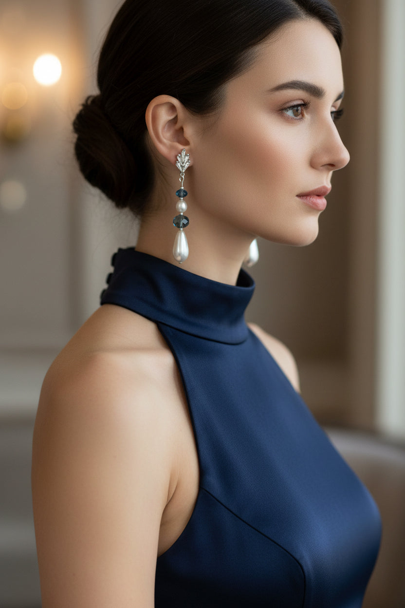 Pair of earrings with pearls and blue crystals. on a white background