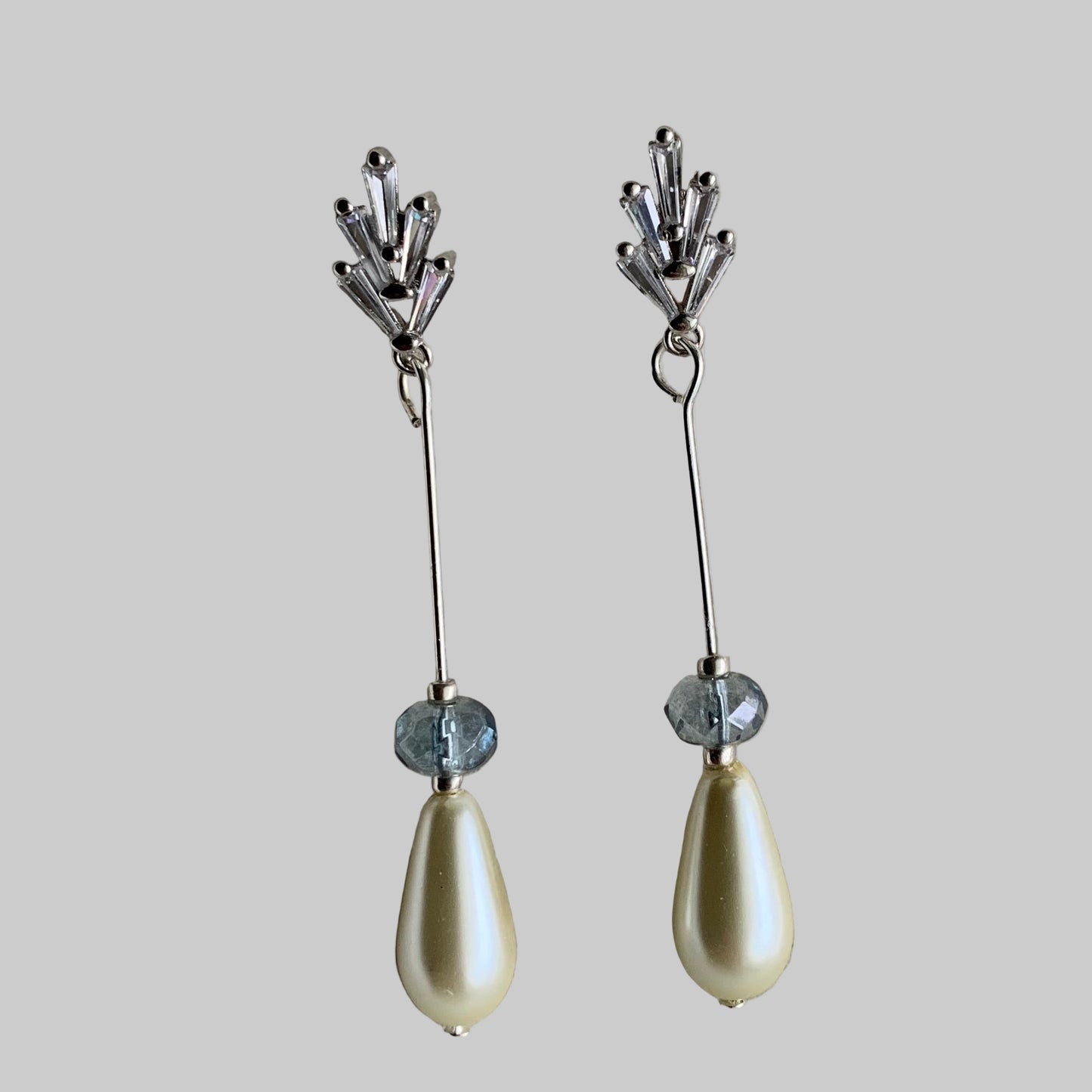 .CZ Baguettes, teardrop pearl earrings  in white metal on neutral background