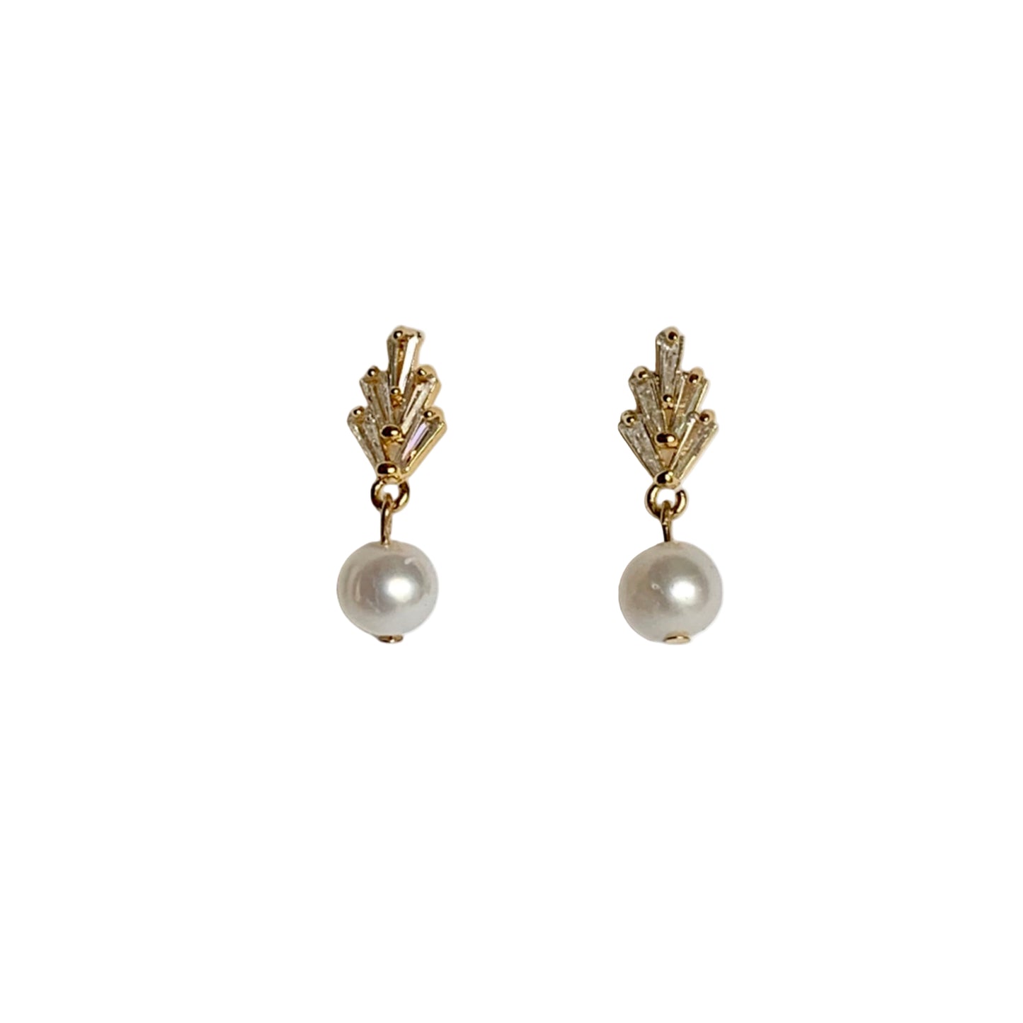 Pair of gold earrings with pearl drops on a light gray background