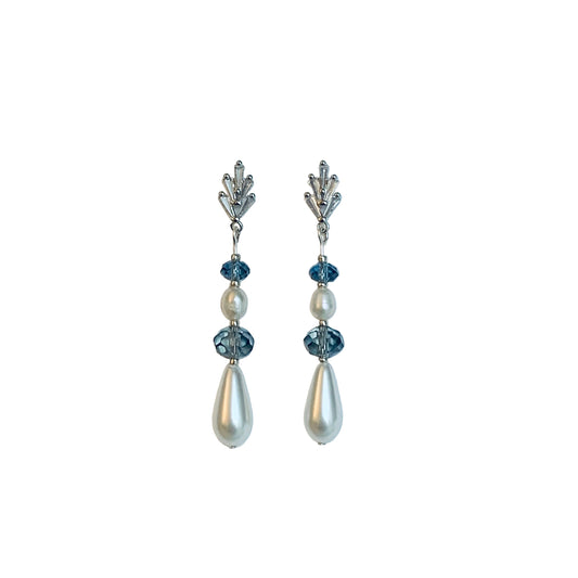 Pair of earrings with pearls and blue crystals. on a white background